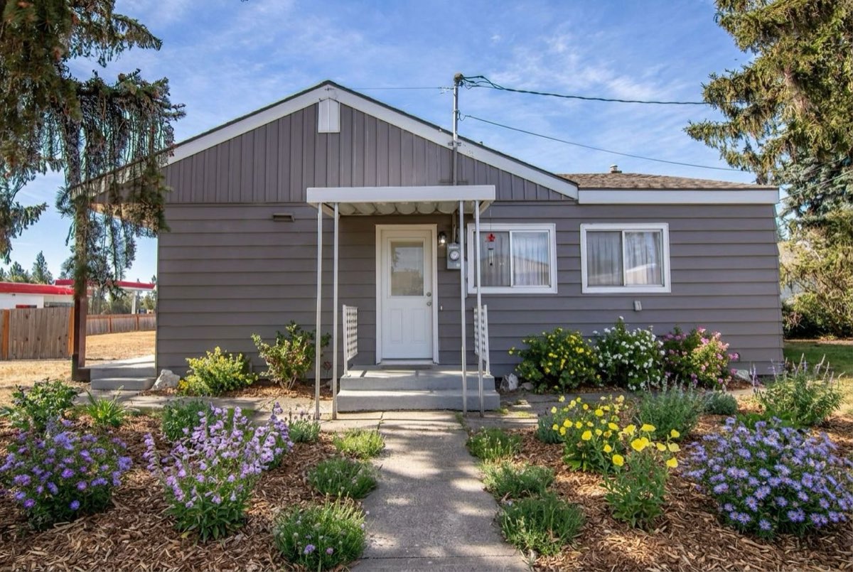 The same yard replanted with native plants. Before replanting it was a single-family house with a plain lawn in front.